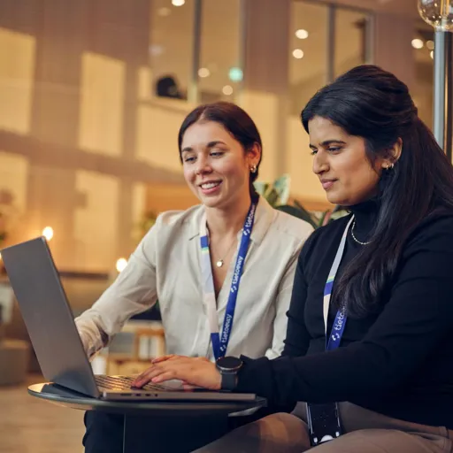Two employees (women) working with laptop together